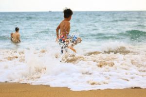 boy on the beach in the sea