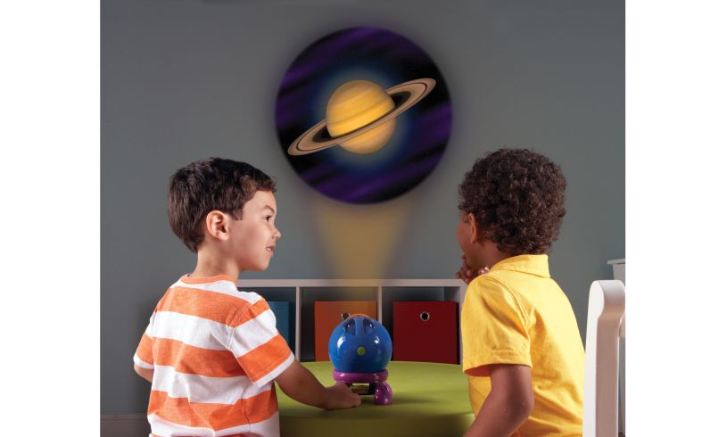 two young boys watching a shining star projector