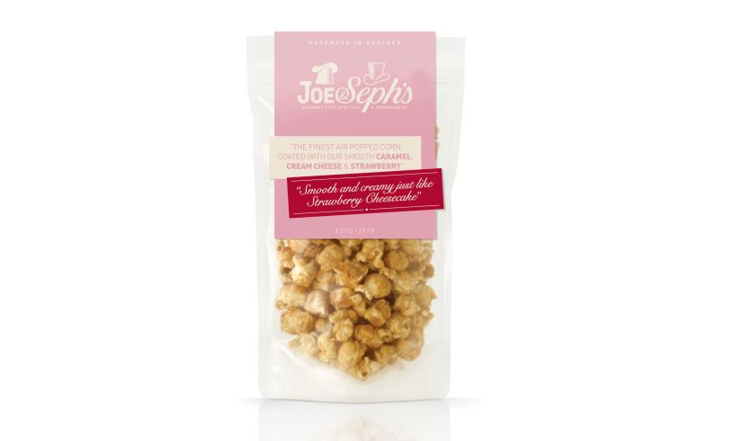 transparent packet of joe & steoh's strawberry cheesecake popcorn.