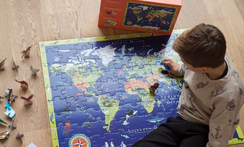 a young boy completing the Discover The World puzzle