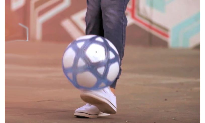 a foot kicking up the smart ball