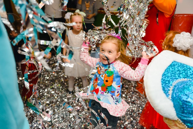 young girl playing in confetti 