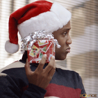 person shaking a small boxed present
