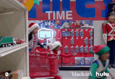 gif of santa and elves running around a toy shop