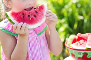 child eating watermelon