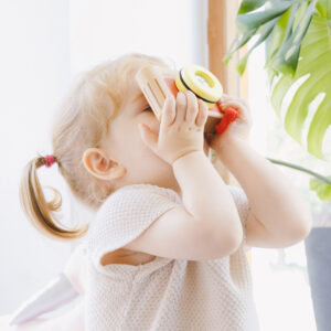 Girl Playing with Wooden Camera