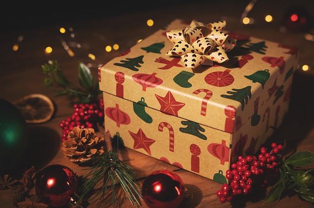 Christmas eve box with bow surrounded by Christmas decorations