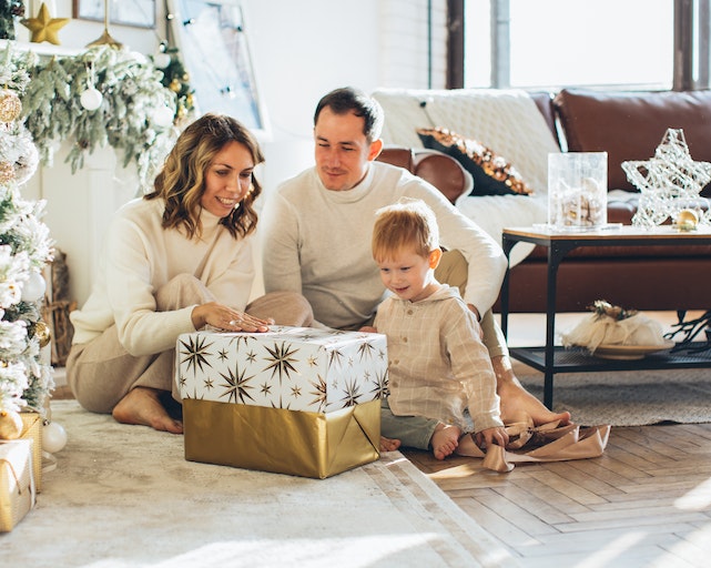 Mum, dad and son looking at Christmad eve box