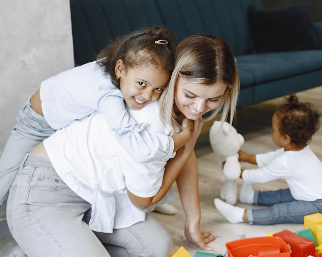Mum and young daughter playing fun indoor games