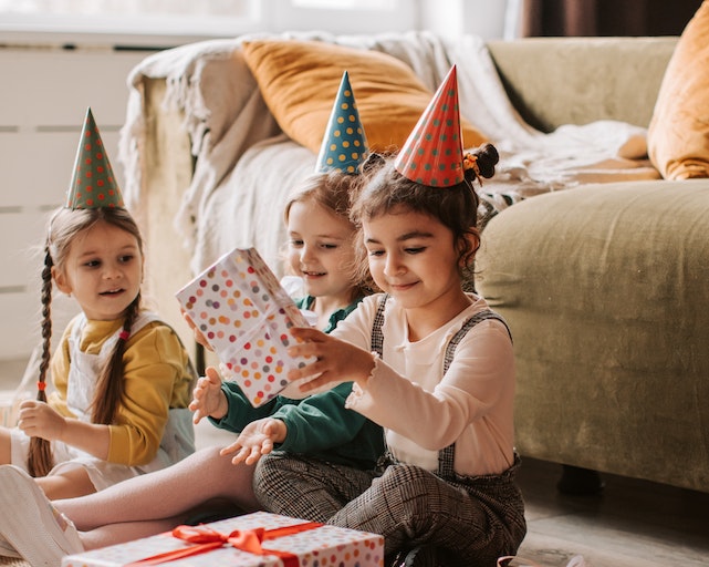 Child opening birthday cards and presents