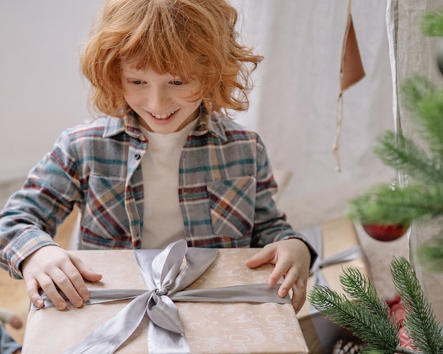 Boy opening Christmas hamper for kids