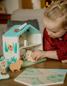 Child with wooden playset