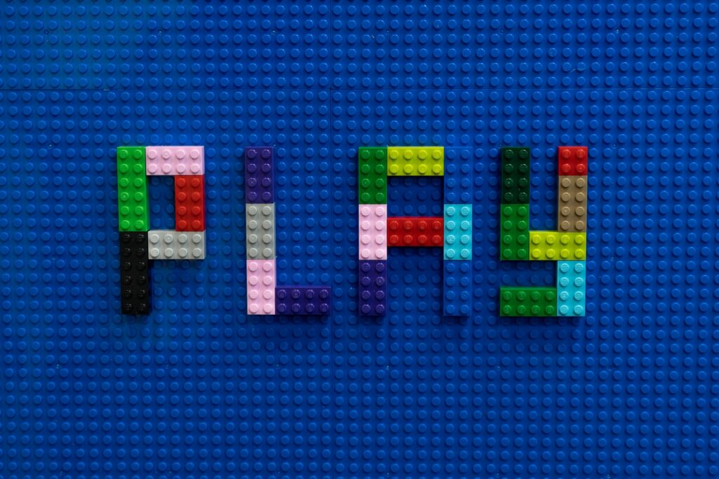 Building block toys spelling the word 'PLAY'